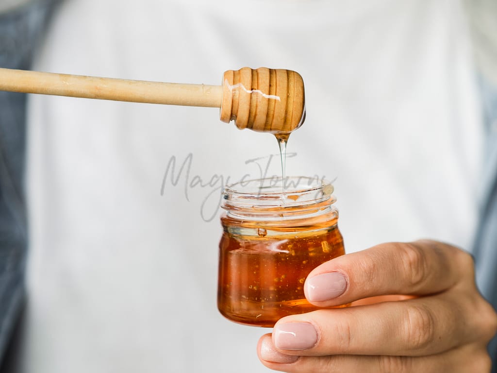 Honey being poured in a jar
