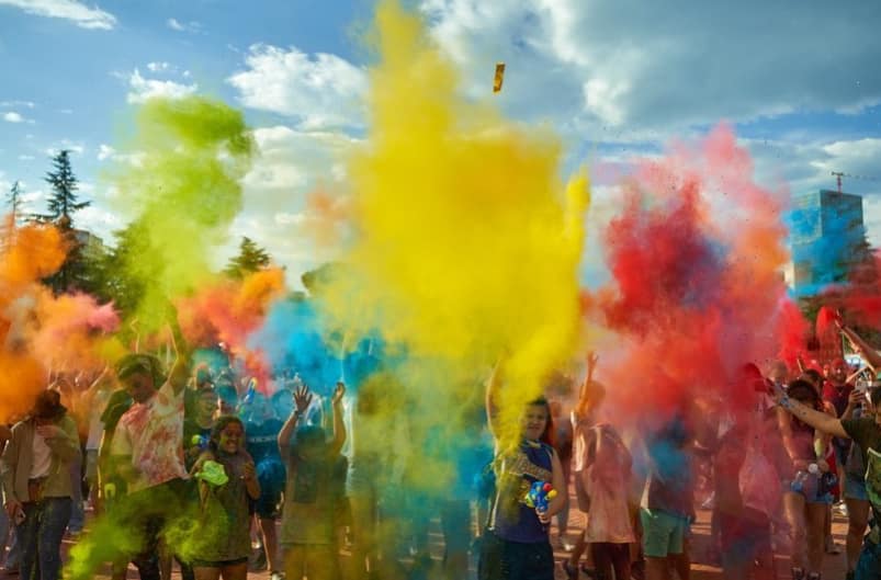Best Festivals in Albania In 2026 13 Colour Day Festival in Tirana, Albania with a crowd celebrating in clouds of colorful powder